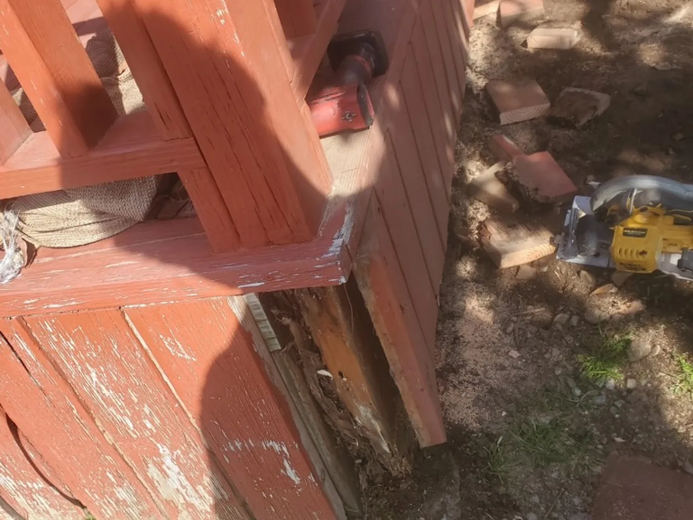 Before: Backyard fence with rotted posts and failing boards at ground level