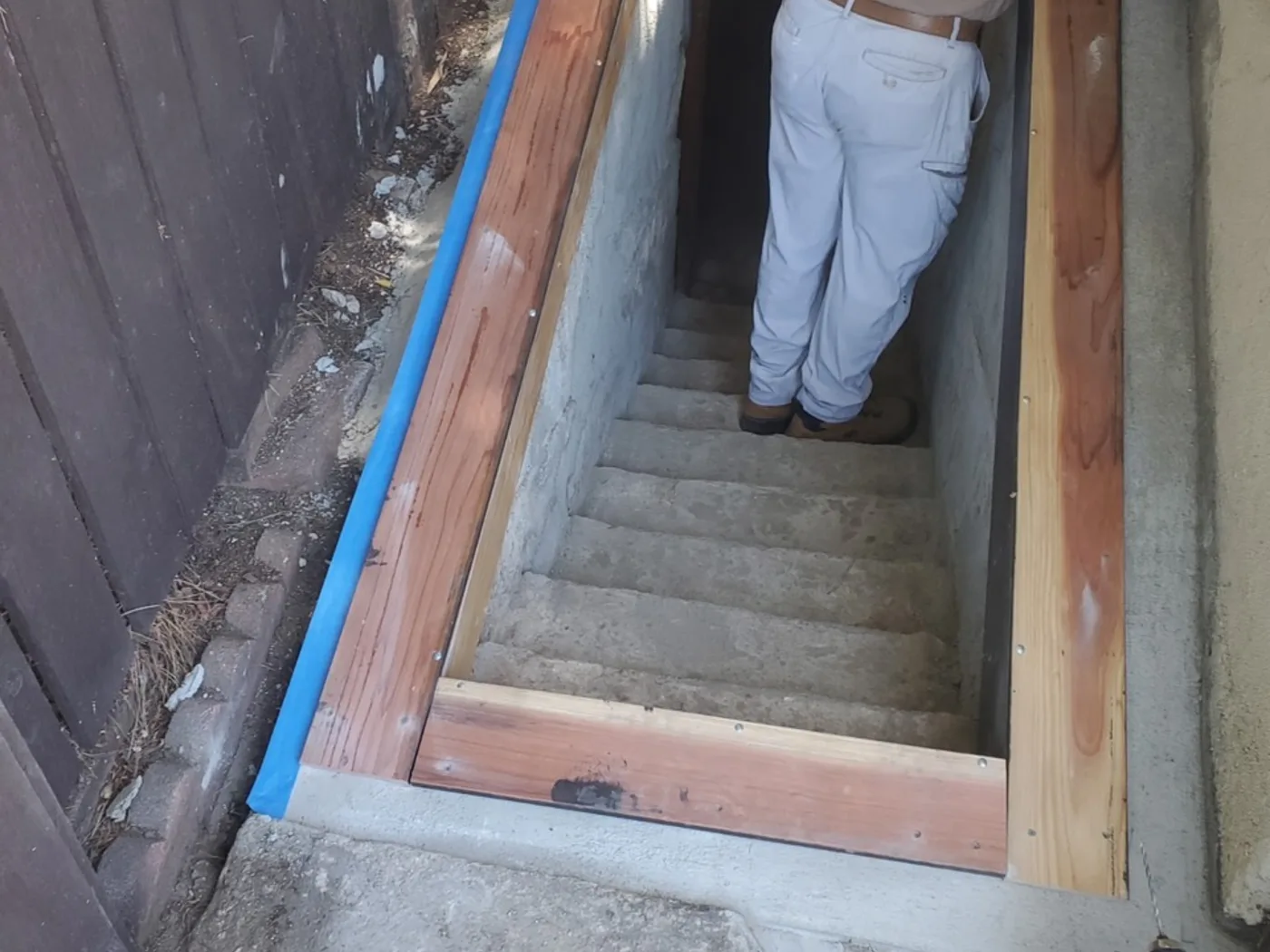 After: Rebuilt basement stairway with new forms and fresh concrete steps
