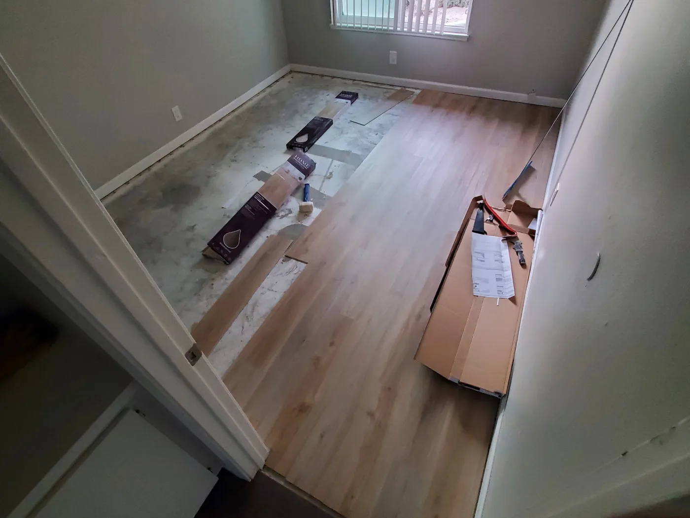 After: The same room part-way through a new plank floor installation