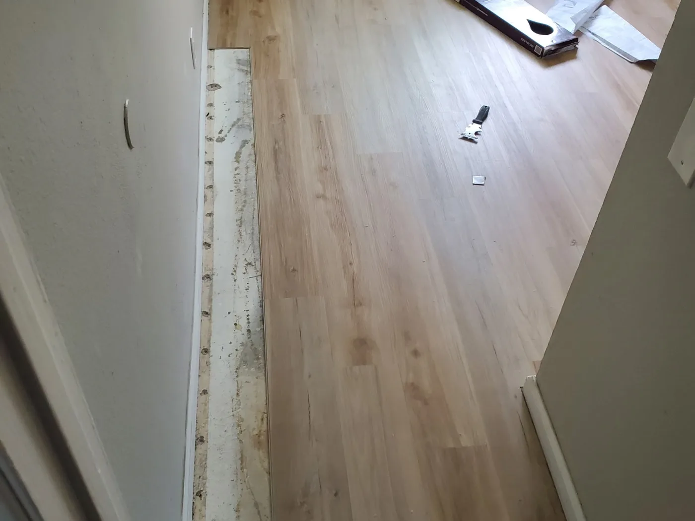After: Same landing with fresh light hardwood installed